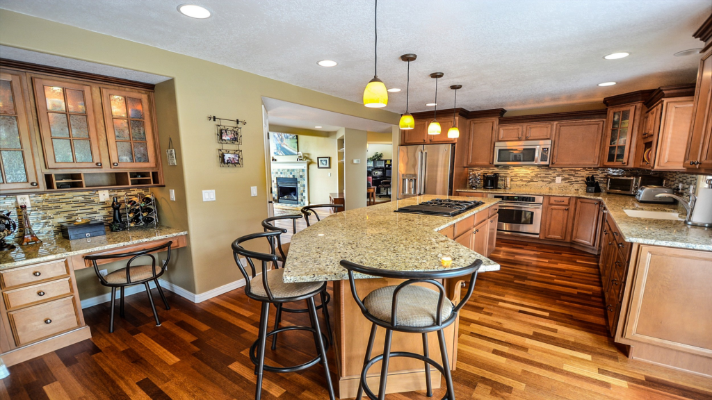 Stylish kitchen remodel in Tuscaloosa featuring a spacious island, stainless steel appliances, and custom cabinetry.